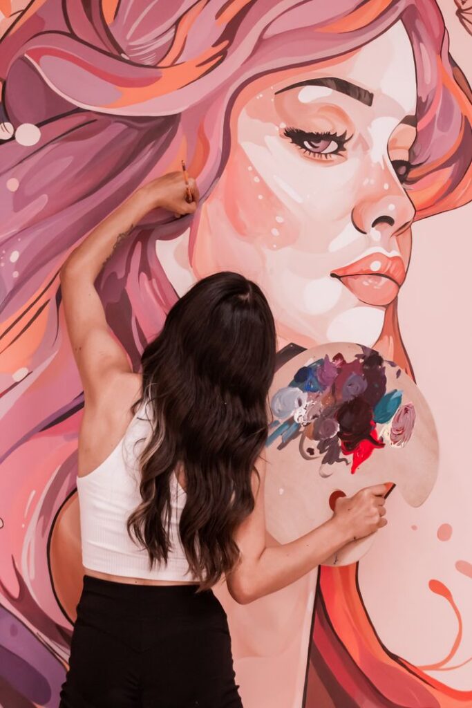 Crafting Captivating Headlines: Your awesome post title goes here Artist painting a vibrant mural of a woman on a wall in Adana, Türkiye.